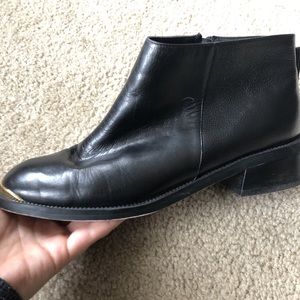 Gold tipped black leather boots